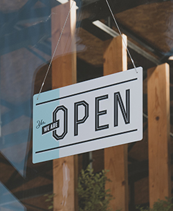 open sign through window of business